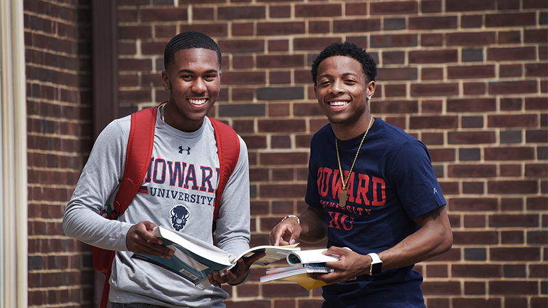 Students reading a textbook Students on reading a textbook
